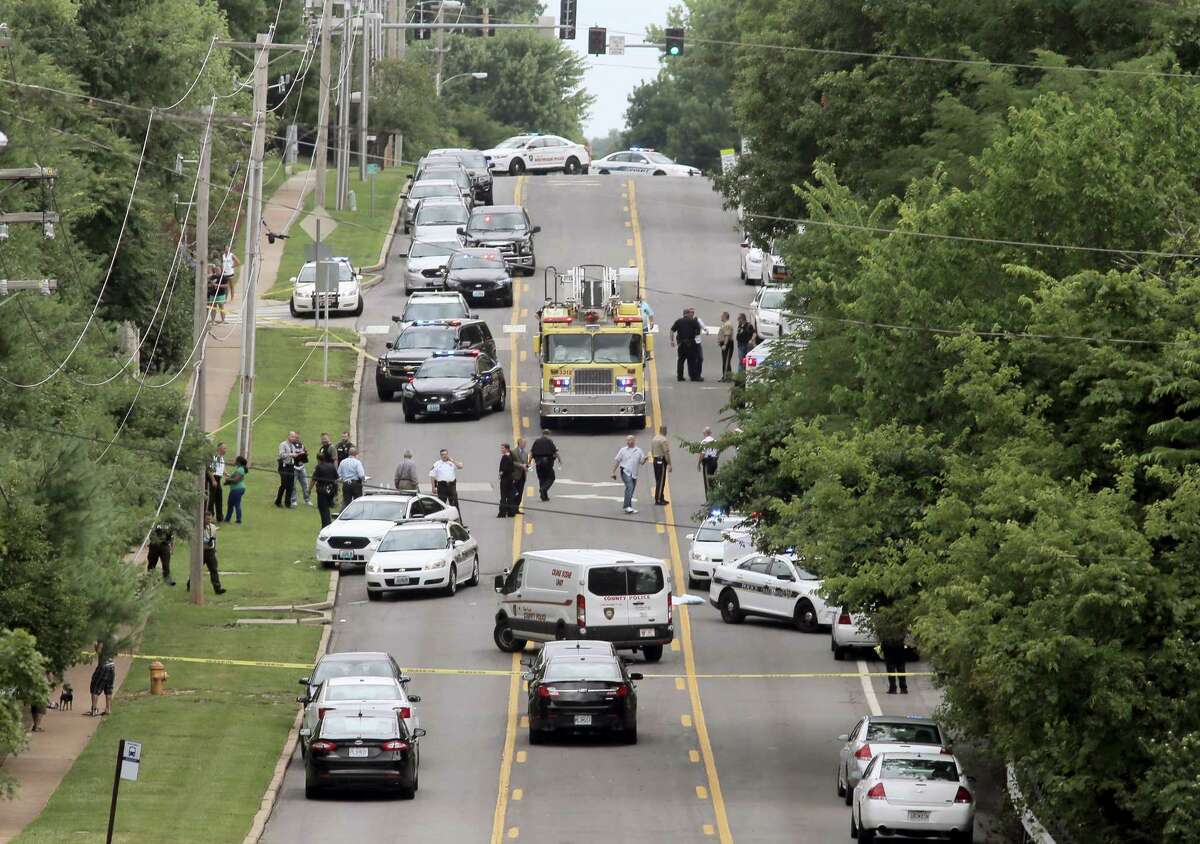 Police investigate a scene in Ballwin, Mo., Friday, July 8, 2016, after a Ballwin police officer was shot during a confrontation with a man on a street. Authorities say the wounded police officer is hospitalized didn’t offer any immediate word about the officer’s medical status. A suspect is in custody, and a handgun has been recovered.