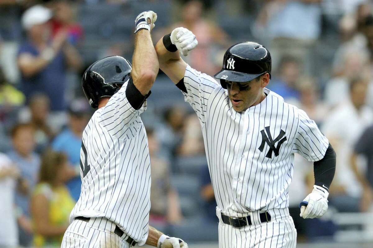 Jacoby Ellsbury, right, celebrates with Brett Gardner after hitting a two-run home run in the sixth inning Saturday.