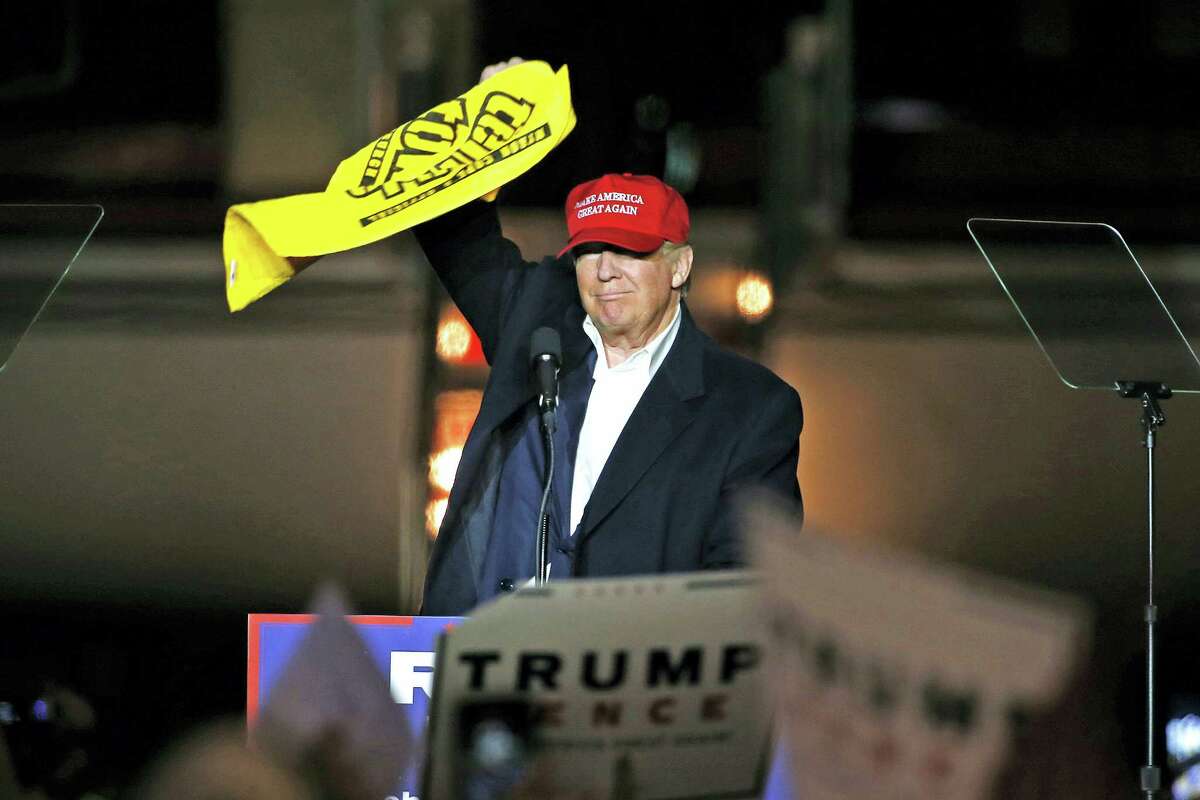 Republican presidential candidate Donald Trump waves a Pittsburgh Steelers Terrible Towel during a plane-side rally in a hanger at Pittsburgh International Airport in Imperial, Pa. on Nov. 6, 2016.