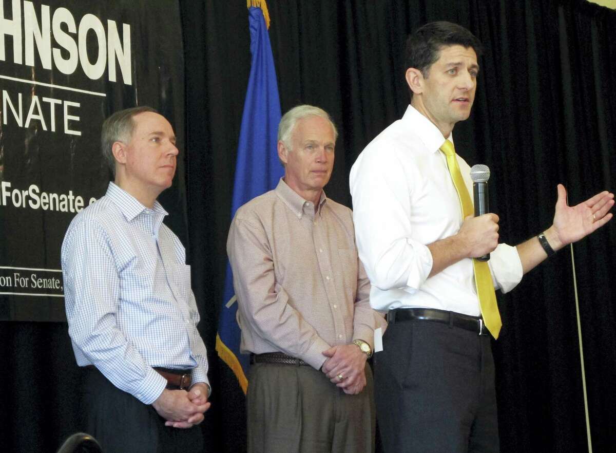 House Speaker Paul Ryan joins Wisconsin state Assembly Speaker Robin Vos, left, and Sen. Ron Johnson, R-Wis., center, at a campaign rally for Johnson on Thursday, May 5, 2016, in Burlington, Wis.
