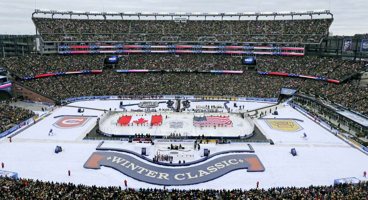 The Canadian and American flags are presented during the national anthems prior the Winter Classic between the Bruins and Canadiens on Friday at Gillette Stadium in Foxborough, Mass.