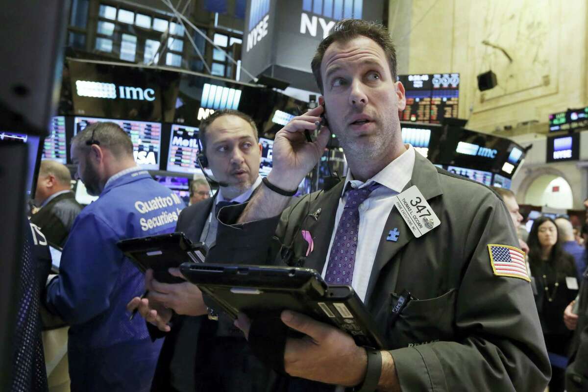 Trader Thomas Cicciari, right, works on the floor of the New York Stock Exchange Friday.