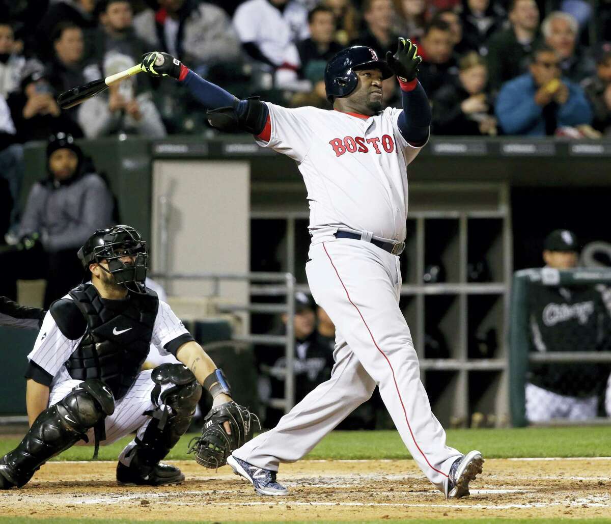Boston Red Sox's David Ortiz watches his two-run home run off Chicago White Sox starting pitcher Carlos Rodon, also scoring Xander Bogaerts, during the fifth inning of a baseball game Wednesday, May 4, 2016, in Chicago. Watching with Ortiz is catcher Dioner Navarro. (AP Photo/Charles Rex Arbogast)