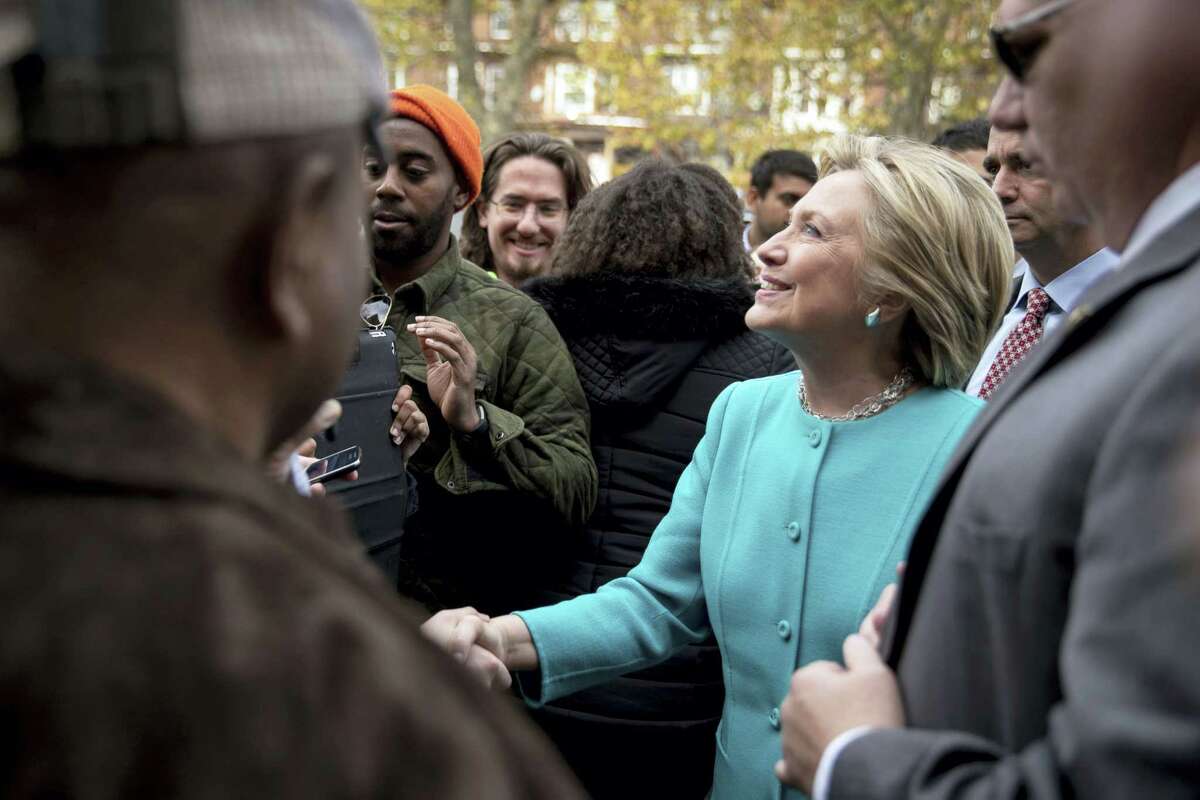 Democratic presidential candidate Hillary Clinton greets people outside Cedar Park Cafe in Philadelphia on Nov. 6, 2016.