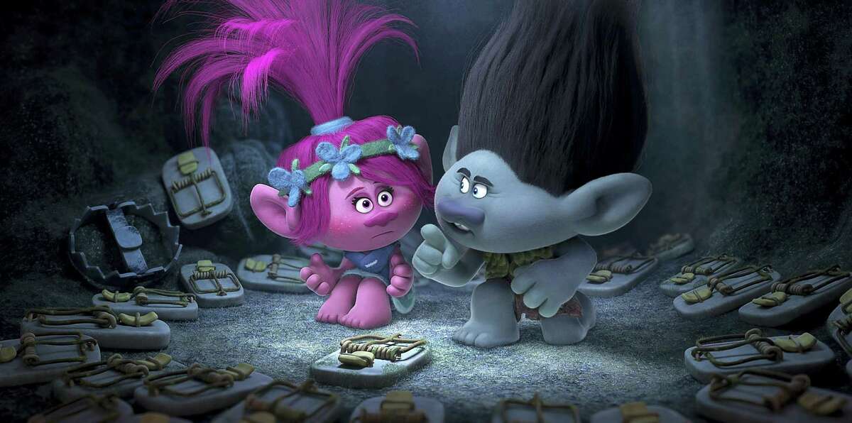 This image released by Dreamworks Animation shows characters Poppy, left, voiced by Anna Kendrick, and Branch, voiced by Justin Timberlake in a scene from “Trolls.”