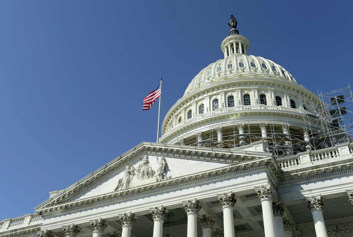 An American flag flies over Capitol Hill in Washington Tuesday as lawmakers return from a 7-week break.