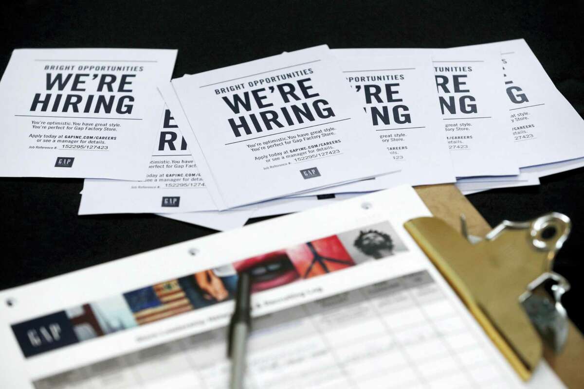 In this Tuesday, Oct. 6, 2015, file photo, job applications and information for the Gap Factory Store sit on a table during a job fair at Dolphin Mall in Miami. Fewer Americans applied for unemployment benefits last week of Aug. 2016, another sign the U.S. job market remains healthy despite a downshift in hiring in August. The Labor Department says the number of applications for jobless aid slid by 4,000 last week to a seasonally adjusted 259,000, lowest since mid-July.