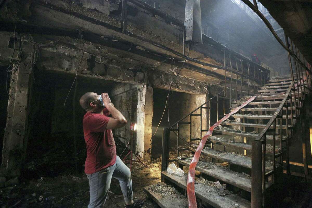 An Iraqi man looks for victims at the site of a car bomb attack at a commercial area in Karada neighborhood, Baghdad, Iraq, Sunday, July 3, 2016. At least 175 people have been killed and more than 100 wounded in two separate bomb attacks in the Iraqi capital Sunday morning, Iraqi officials said.