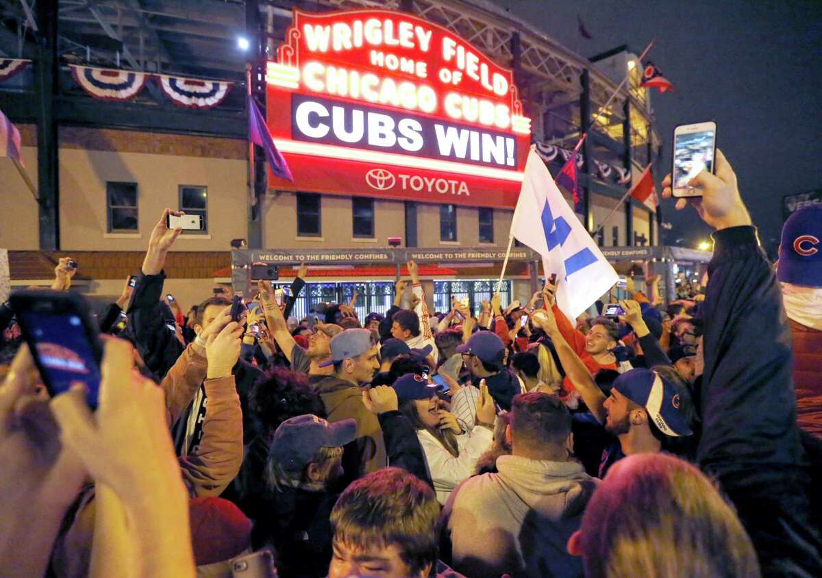 Cubs fans celebrate in front of Wrigley Field in Chicago.