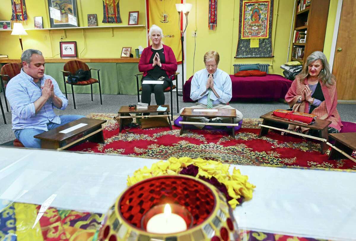 Kris Yaggi of Guilford, Rocky Pickering of Guilford, Paul Gustafson of Madison, and Su Dowling-Slover of Killingworth, after a Red Tara Dedication prayer together at the Buddhist Meditation Center of Guilford.