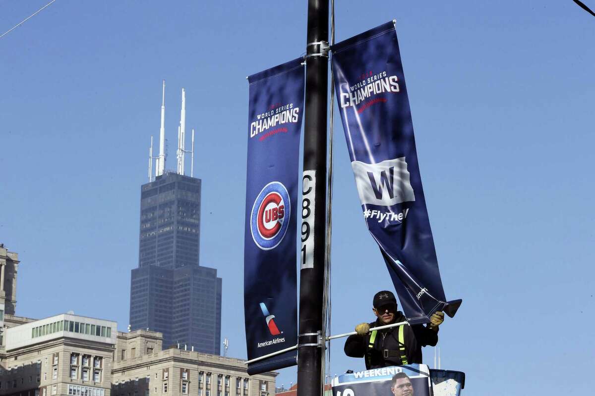 Chicago Cubs banners are installed in preparation for the parade and rally to celebrate the Cubs World series victory.