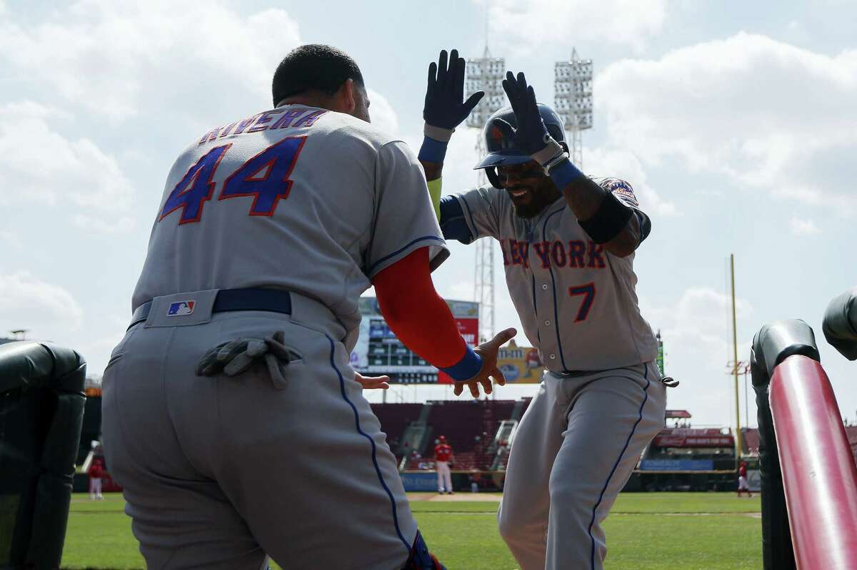 New York’S Jose Reyes celebrates in the dugout after hitting a solo home run off Cincinnati Reds starting pitcher Anthony DeSclafani in the first inning Wednesday in Cincinnati. The Mets won 6-3.