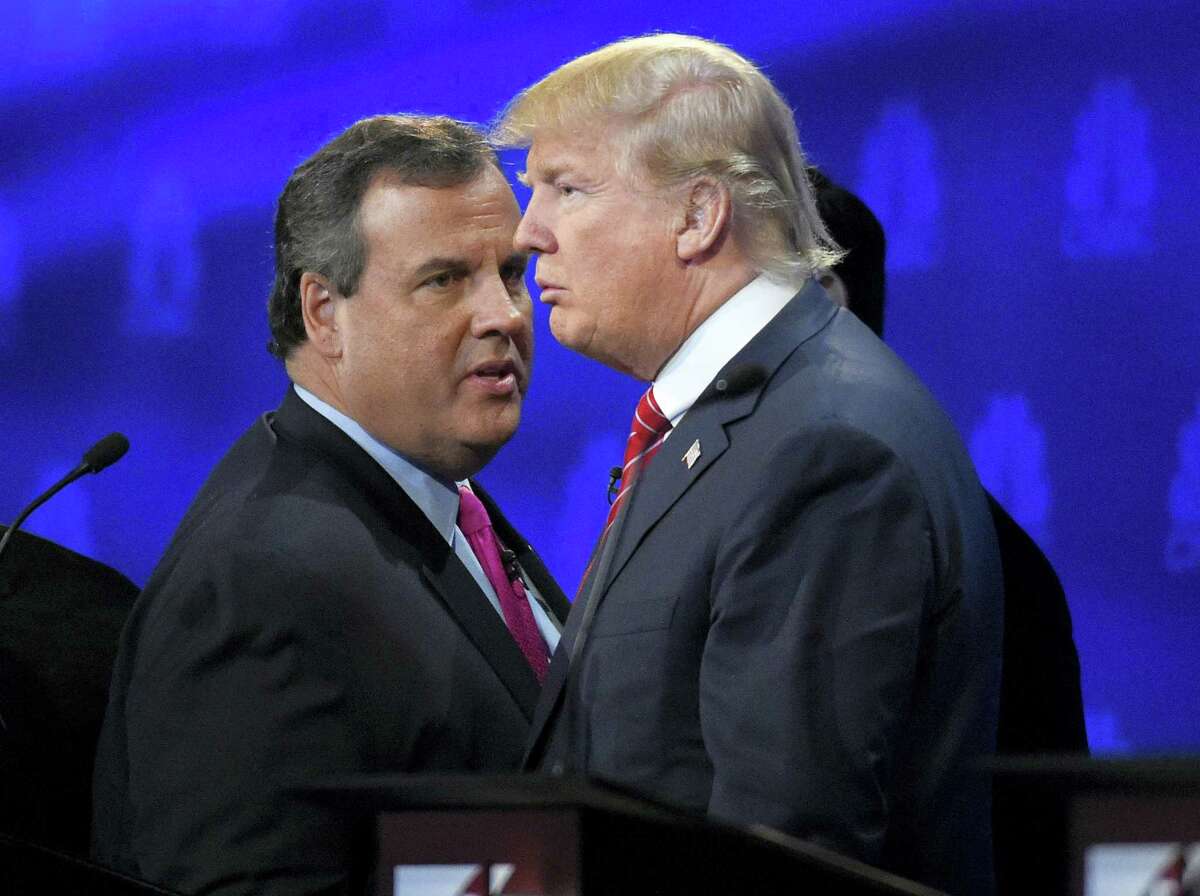 FILE - In this Oct. 28, 2016 file photo, New Jersey Gov. Chris Christie and Donald Trump talk during a break in the CNBC Republican presidential debate at the University of Colorado in Boulder, Colo. Christie had better be hungry: He’s got a lot of harsh words to eat about Trump now that he’s endorsed the billionaire. Trump, in turn, has some tough things about Christie to start walking back now that the two men are suddenly allies instead of antagonists in the Republican presidential race.