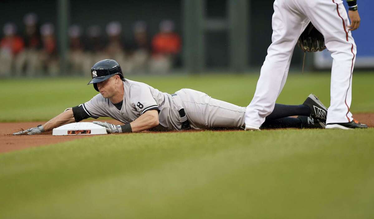 New York Yankees’ Brett Gardner slides into second with a double during the first inning Tuesday. The Yankees fell to the Baltimore Orioles 4-1.