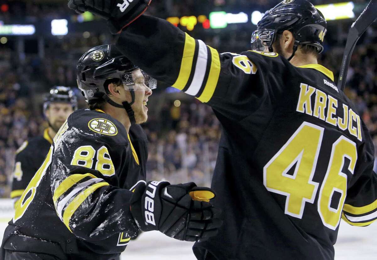 Boston Bruins left wing David Pastrnak (88) celebrates his goal against the Pittsburgh Penguins with teammate David Krejci (46) in the second period Wednesday.