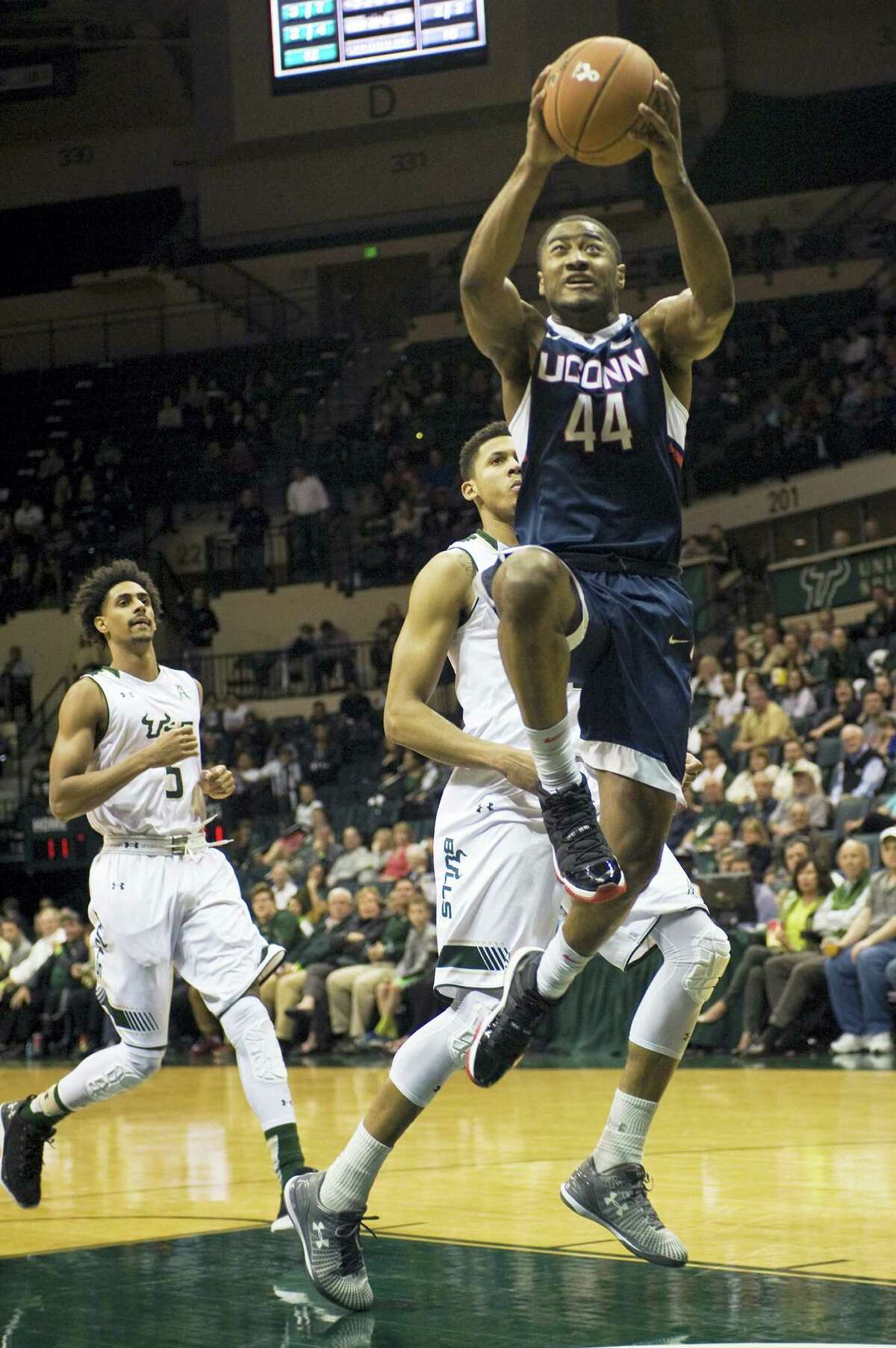 UConn’s Rodney Purvis (44) scores past South Florida’s Nehemias Morillo (5) and Angel Nunez, center, during the first half Thursday in Tampa, Fla.