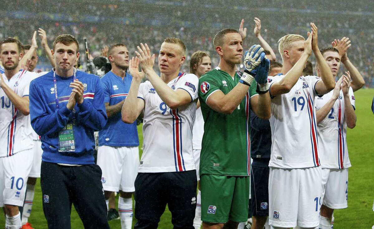 Iceland’s players applaud supporters at the end of their match against France on Sunday.