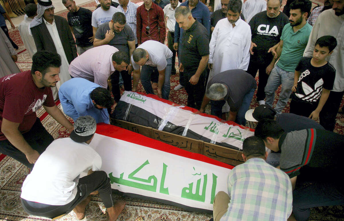 Mourners carry the Iraqi flag-draped coffins of bomb victims, Talib Hassan, 35, and Hamza Jabbar, 37, during their funeral processions at the holy shrine of Imam Ali in Najaf, 100 miles (160 kilometers) south of Baghdad, Iraq on July 3, 2016. Dozens of people have been killed and more than 100 wounded in two separate bomb attacks in the Iraqi capital Sunday morning, Iraqi officials said.