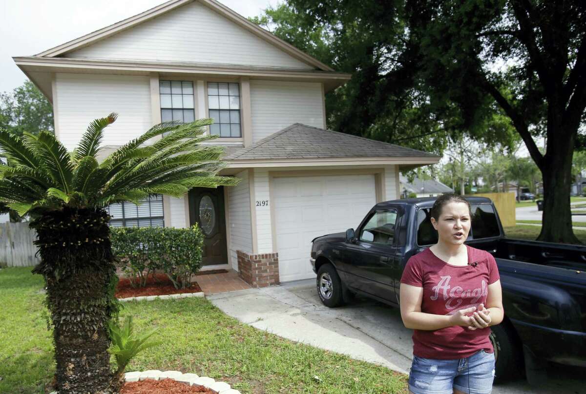 In this April 14, 2016 photo, Nicole Caverly stands in front of her home in the Piedmont Park neighborhood in Apopka, Fla. Caverly began renting in the Piedmont Park neighborhood this year.