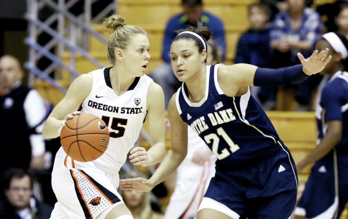 Oregon State guard Jamie Weisner, left, drives on Notre Dame guard Kayla McBride during the first half of an NCAA college basketball game in Corvallis, Ore., Sunday, Dec. 29, 2013. (AP Photo/Don Ryan)