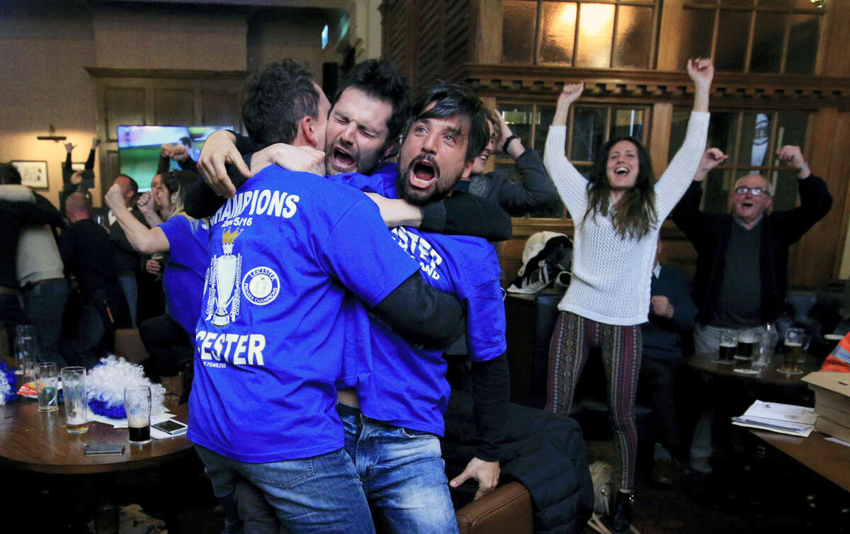 Leicester City fans react in Hogarths public house in Leicester, central England, after Chelsea’s Eden Hazard scores the equalising goal against Tottenham Hotspur in their English Premier League soccer match. The match ended 2-2 resulting in Leicester City winning the Premier League, Monday.
