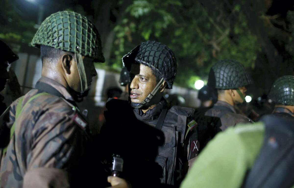 Bangladeshi security personnel stand guard near a restaurant that has reportedly been attacked by unidentified gunmen in Dhaka, Bangladesh, Friday, July 1, 2016. Local media reported that a group of attackers took hostages inside a restaurant frequented by both locals and foreigners in a diplomatic zone in Bangladesh’s capital.