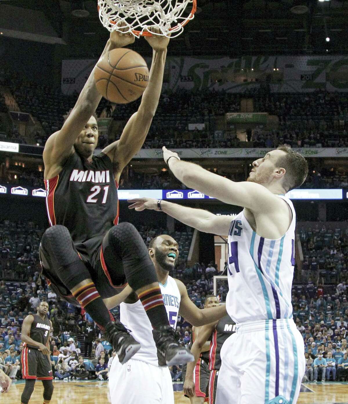 In this Monday, April 25, 2016 photo, Miami Heat’s Hassan Whiteside (21) dunks over Charlotte Hornets’ Frank Kaminsky (44) during the first half in Game 4 of an NBA basketball playoffs first-round series in Charlotte, N.C. Whiteside will be one of the most coveted targets when free agency begins FrIday, July 1, and there’s no guarantee that the center whose career was resuscitated by the Miami Heat will be back with them next season.