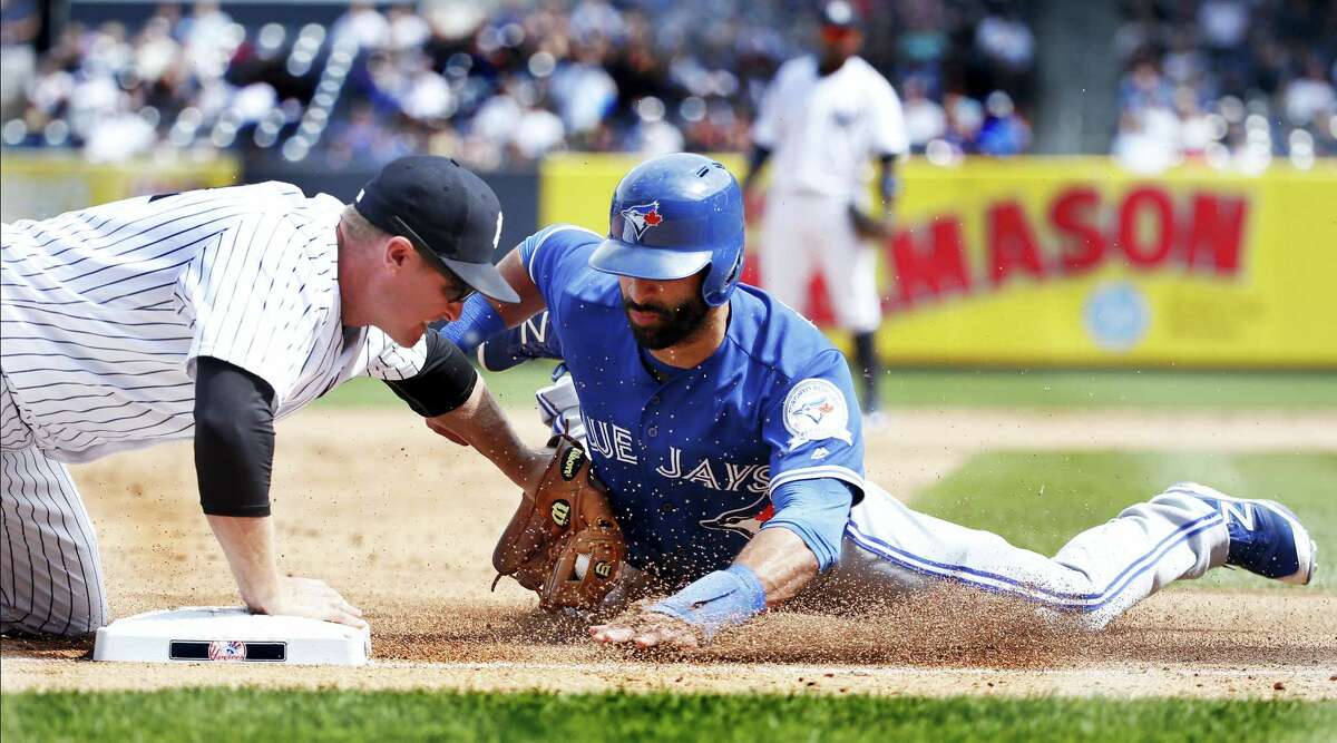 New York Yankees third baseman Chase Headley tags out Toronto’s Jose Bautista out at third in the fifth inning Monday. The Yankees won 5-3.