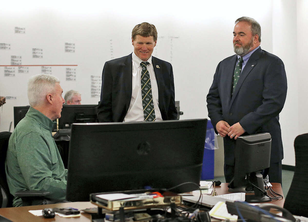 Green Bay Packers general manager Ted Thompson, left, president Mark Murphy, center, and head coach Mike McCarthy talk inside the ‘war room’ during the 2016 NFL draft.