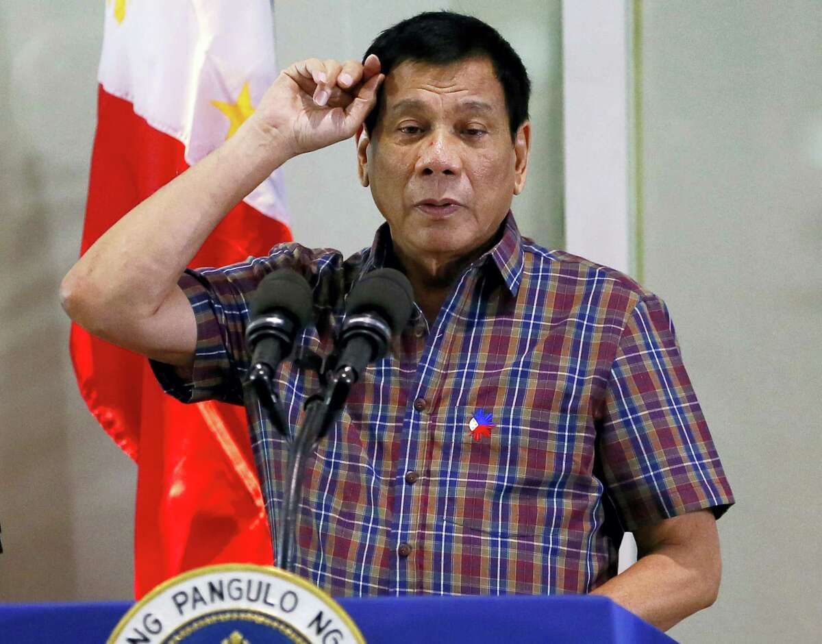 In this Aug. 31, 2016, file photo, Philippine President Rodrigo Duterte gestures as he addresses Overseas Filipino Workers who were repatriated back to the country at the Ninoy Aquino International Airport in Pasay city, south of Manila, Philippines. Duterte, who disparaged the pope and others who controvert his worldview, warns U.S. President Barack Obama on Monday, Sept. 5, 2016, not to question him about extrajudicial killings.
