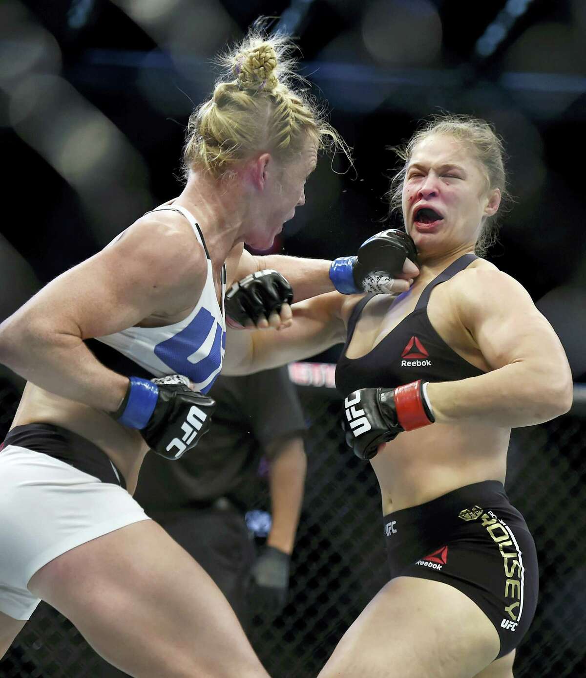 Holly Holm, left, punches Ronda Rousey during their UFC 193 bantamweight title fight in Melbourne, Australia.