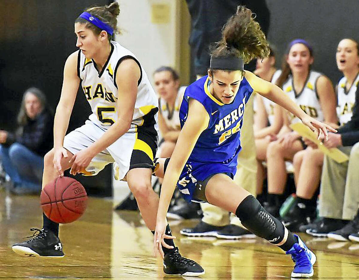 (Catherine Avalone – GameTime CT) Mercy junior Keri Kernisan attempts to steal back the ball from Hand’s Gillian Draemer defends in a 77-56 win for the Mercy Tigers earlier this season in Madison.