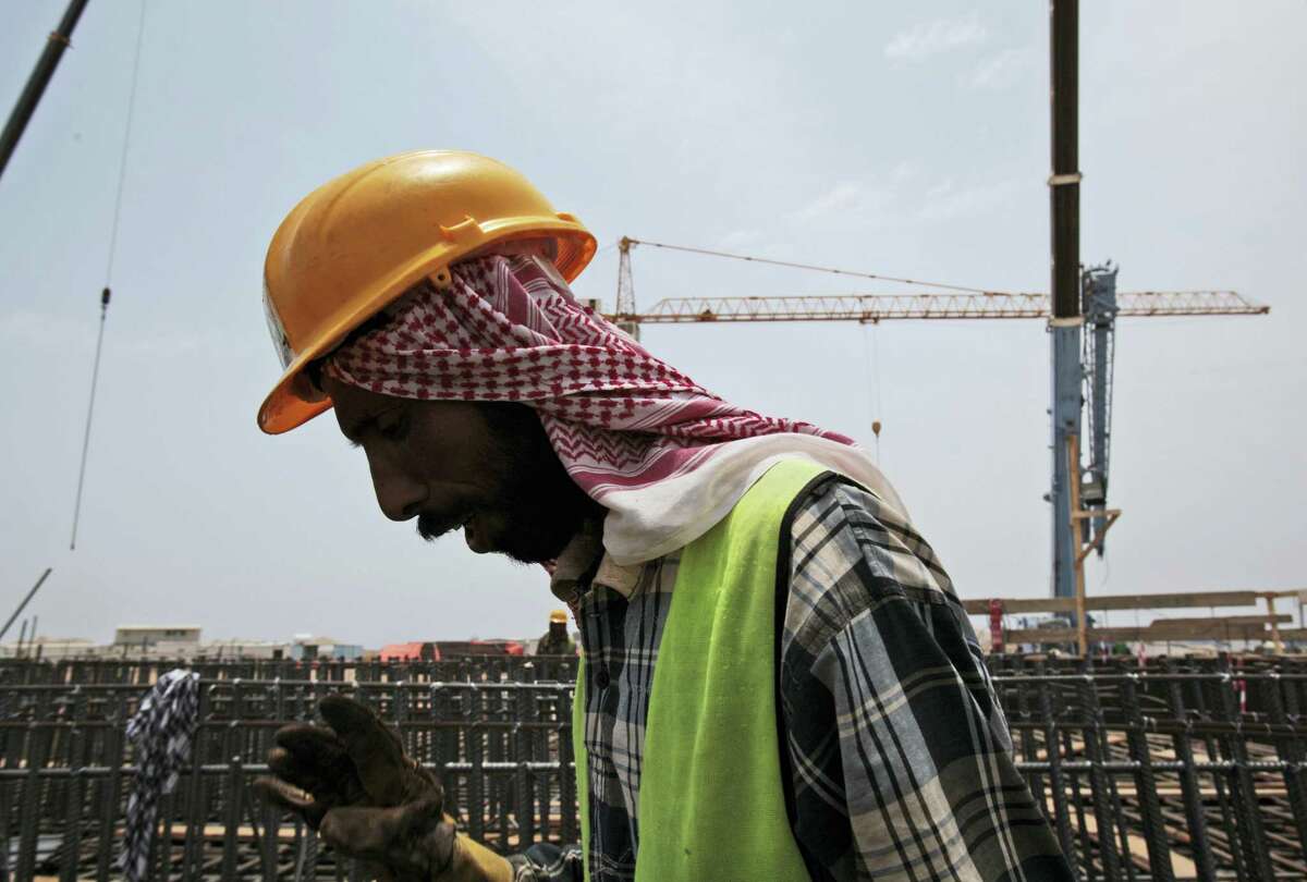 In this May 8, 2014 photo a man works on construction of the Kingdom Tower, a planned 252-story building, which aims to become the world’s tallest skyscraper when complete, in Jiddah, Saudi Arabia.