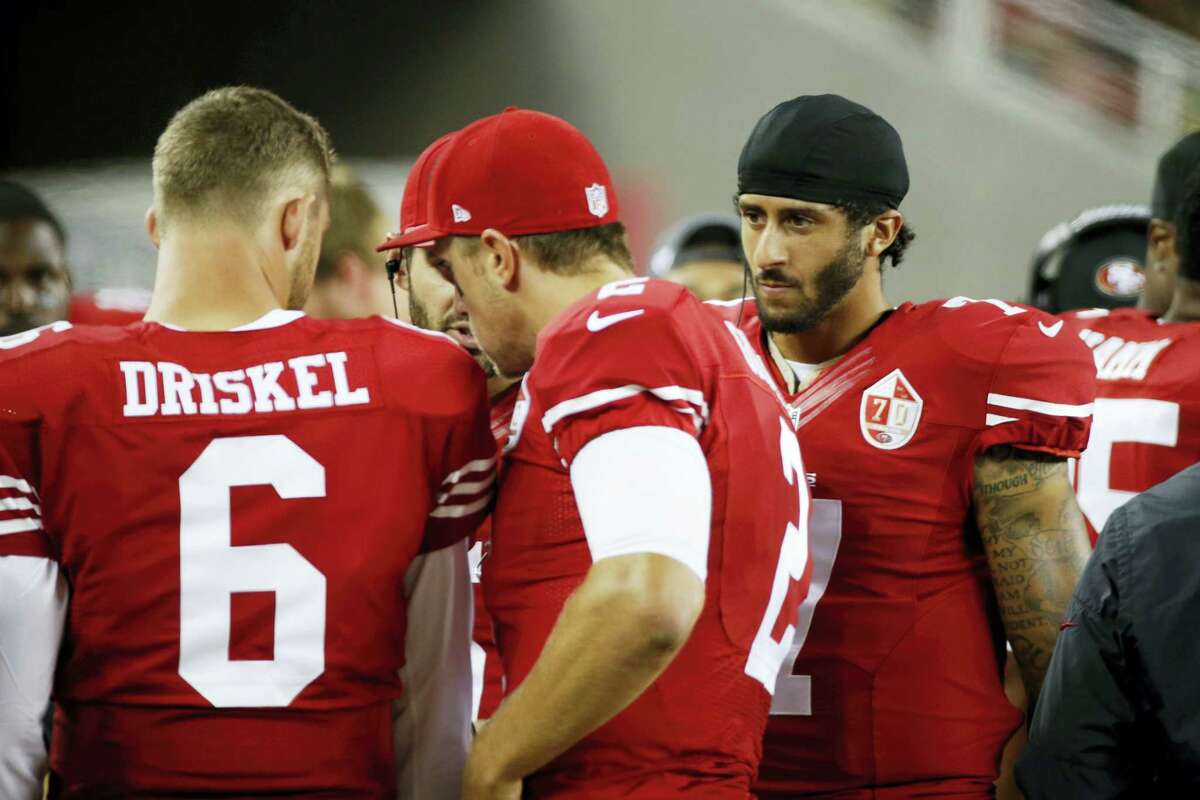 San Francisco 49ers quarterback Colin Kaepernick, right, on the sidelines during the second half of an NFL preseason football game against the Green Bay Packers on Aug. 26, 2016, in Santa Clara, Calif. Also shown are quarterbacks Jeff Driskel, left, and Blaine Gabbert, center.