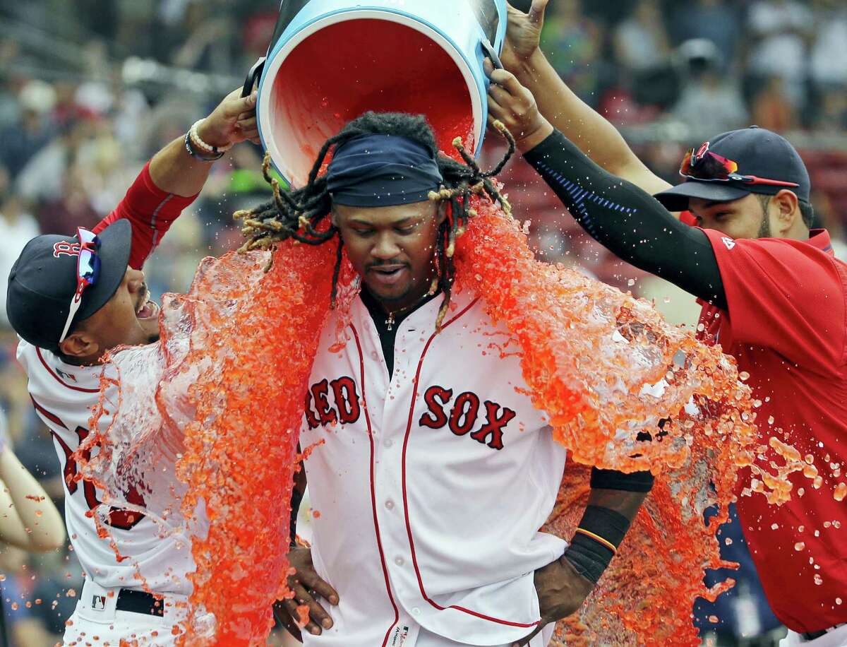 Boston’s Hanley Ramirez is doused by teammates Mookie Betts, left, and Eduardo Rodriguez after they defeated the Tampa Bay Rays.
