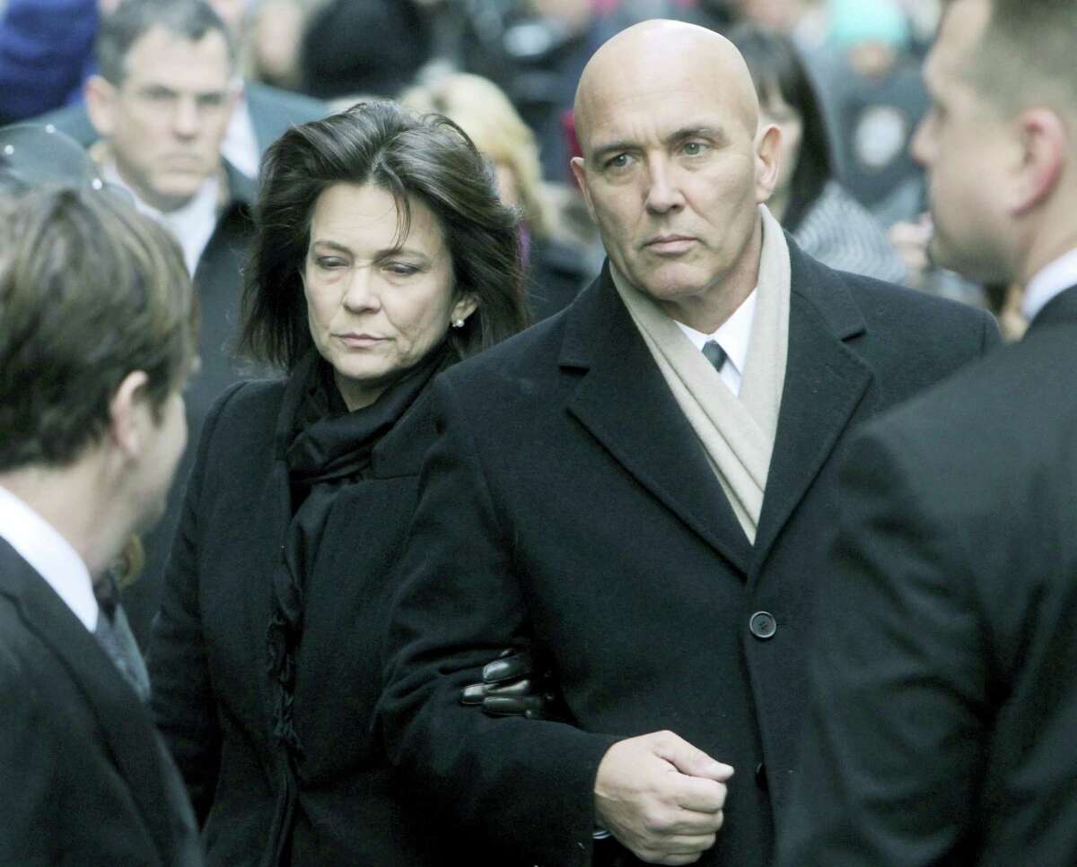 Madonna Badger, left, and Michael Borcina arrive for the funeral of Badger’s three children in New York in 2012.