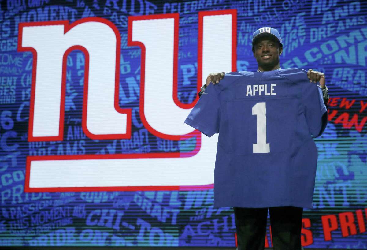 Ohio State’s Eli Apple poses for photos after being selected by New York Giants as the 10th pick in the first round of the 2016 NFL football draft, Thursday, April 28, 2016, in Chicago. (AP Photo/Charles Rex Arbogast)