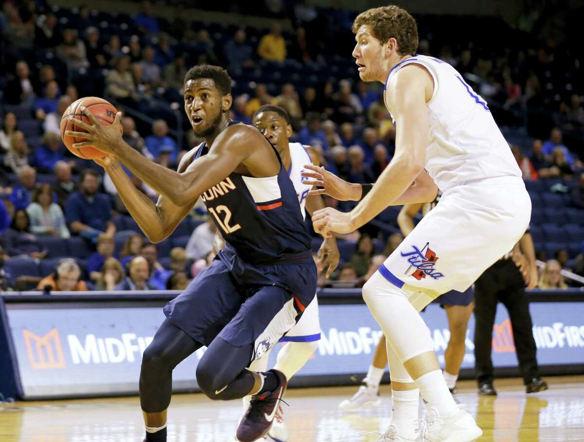UConn’s Kentan Facey, left, drives against Tulsa in the second half Saturday.