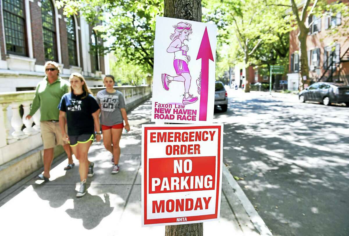 (Arnold Gold-New Haven Register) Signs are posted on Temple St. in New Haven near the start and finish lines of the Faxon Law New Haven Road Race on 9/4/2016.