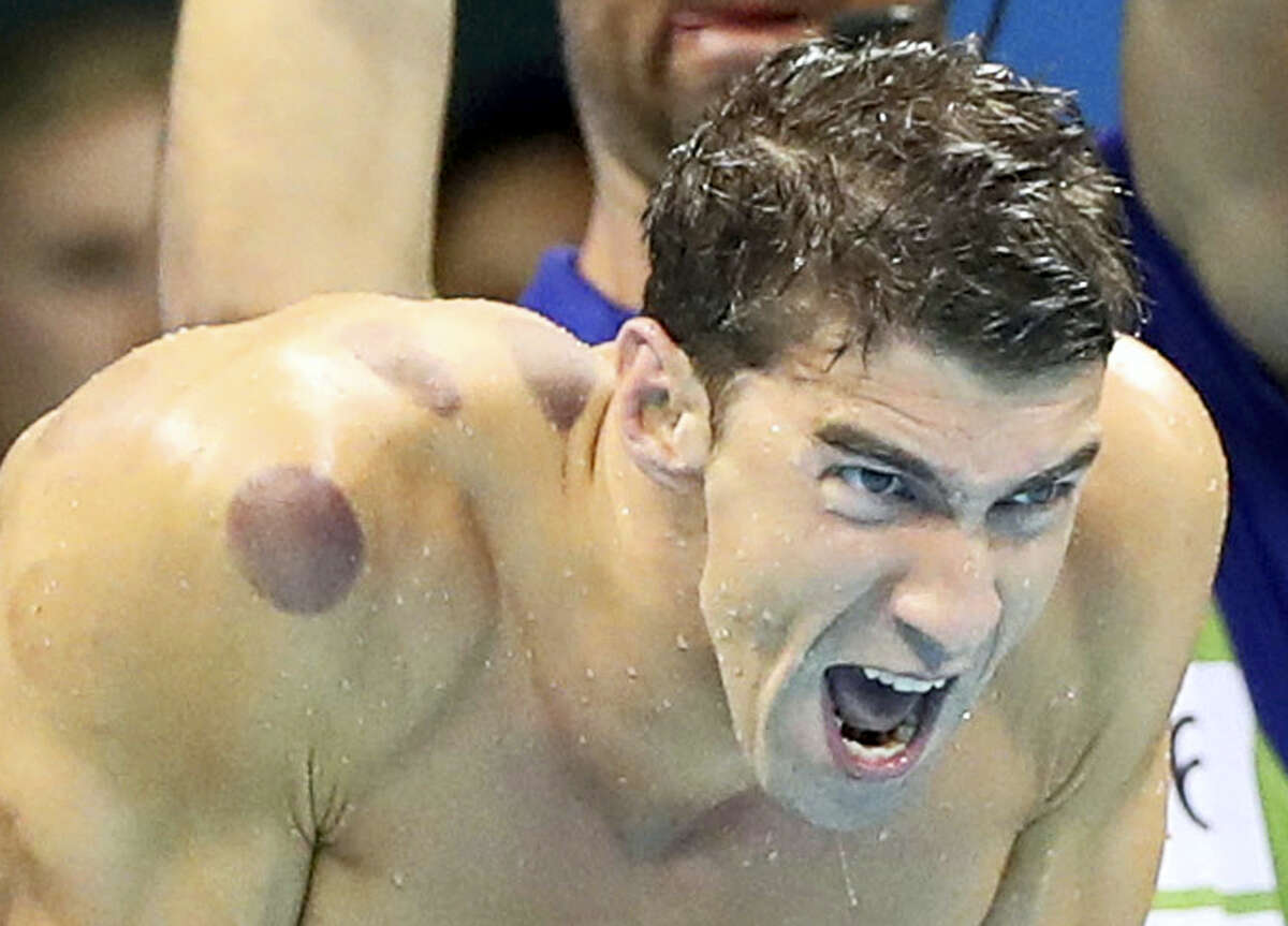 In this Aug. 7, 2016, file photo United States swimmer Michael Phelps encourages his teammates in the final of the men’s 4x100-meter freestyle relay during the swimming competitions at the 2016 Summer Olympics in Rio de Janeiro, Brazil. Phelps recreated an angry face he was caught making by TV cameras ahead of one race at the Games for host Jimmy Fallon during an appearance on NBC’s “Tonight Show” Thursday, Sept. 1, 2016.