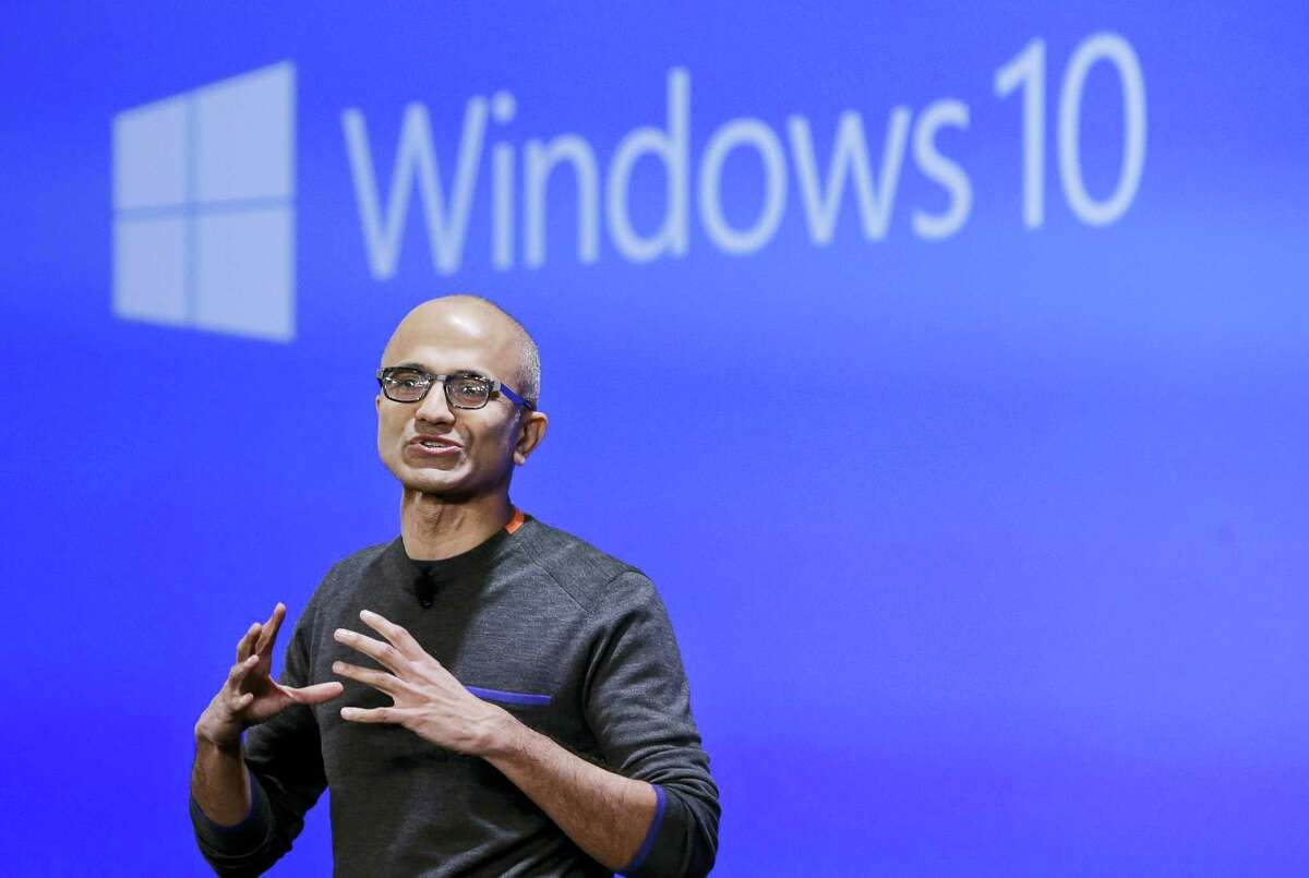 In this Jan. 21, 2015 photo, Microsoft CEO Satya Nadella speaks at an event demonstrating the new features of Windows 10 at the company’s headquarters in Redmond, Wash. As Windows 10 approaches its first birthday, Microsoft is adding new features to its flagship operating software.