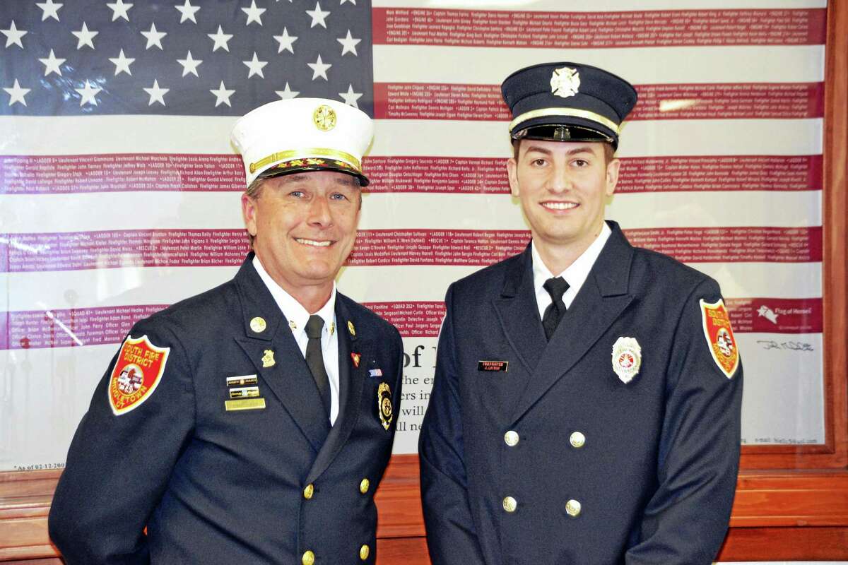Chief Robert Ross poses with the newest member of the department, firefighter Jonathan Listro, an emergency medical technician who graduated in 2014 from the Connecticut Fire Academy.