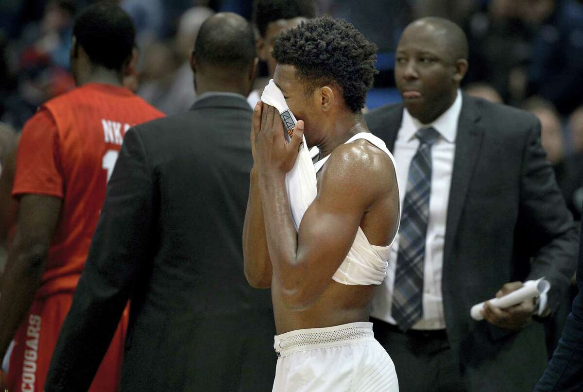 UConn’s Christian Vital wipes his face with his shirt at the end of the 62-46 loss to Houston Wednesday at the XL Center. Vital scored 15 points in the loss.