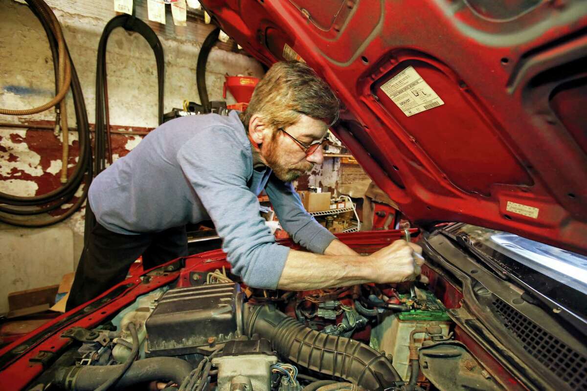 In this March 22, 2016, photo, auto mechanic Joe Valenti changes a battery in a Honda Acura at his garage in Dormont, Pa. Valenti has been keeping his customer’s cars on the road since 1979. On June 28, 2016, the Commerce Department releases its third and final estimate of first-quarter gross domestic product.