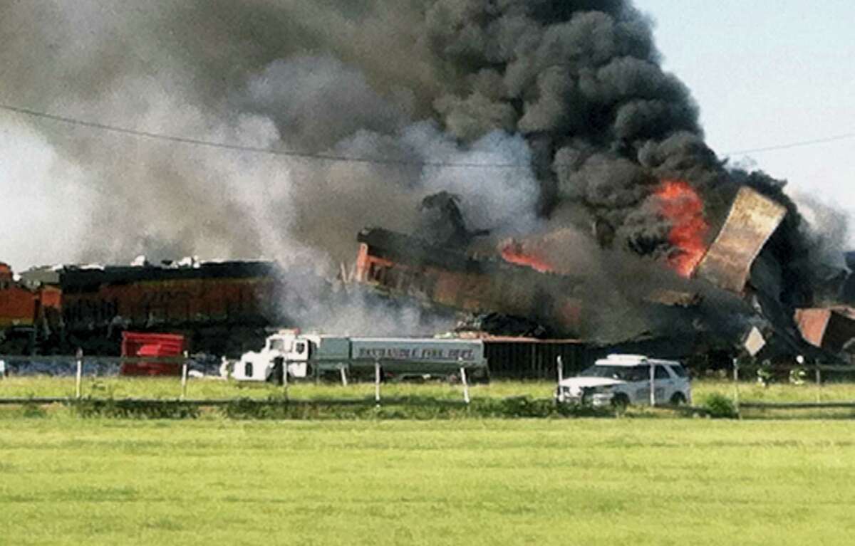 In this photo provided by Billy B. Brown, two freight trains are on fire Tuesday, June 28, 2016, after they collided and derailed near Panhandle, Texas. Texas Department of Public Safety Lt. Bryan Witt says the accident occurred Tuesday morning near the town of Panhandle, about 25 miles northeast of Amarillo. No injuries have been reported.