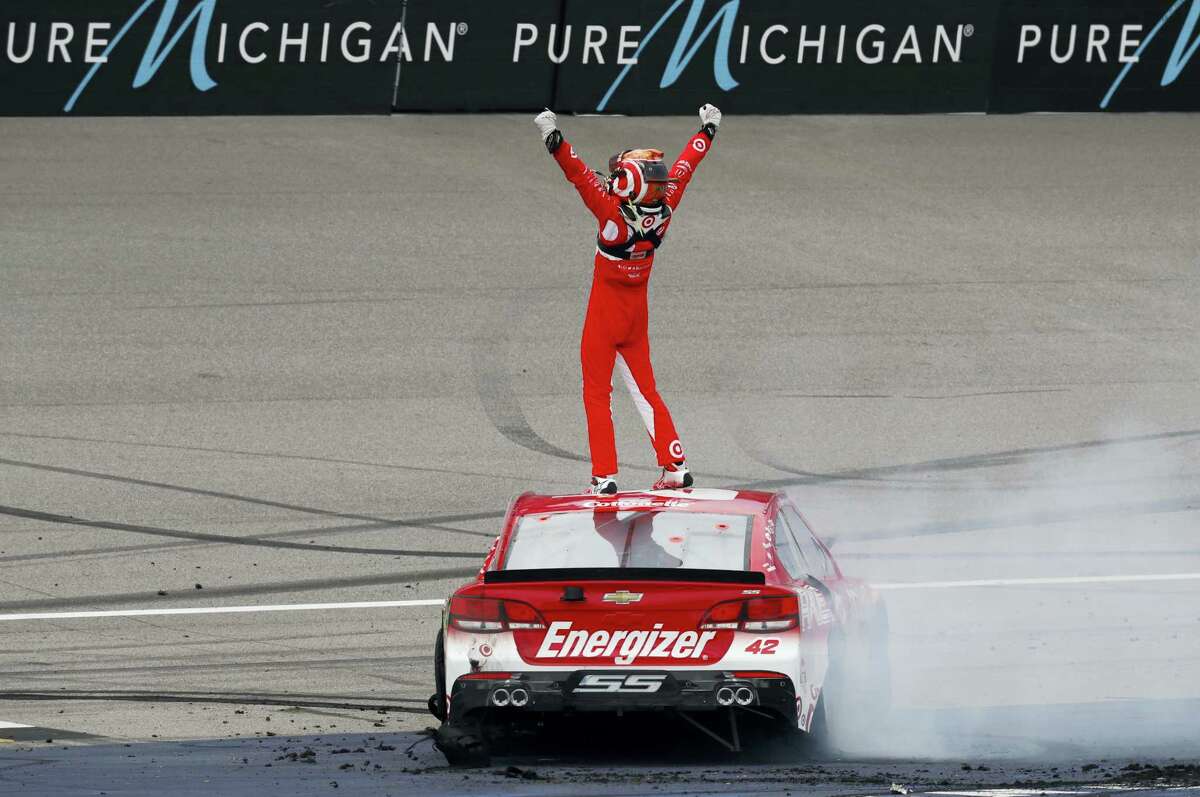 Kyle Larson celebrates winning at Michigan International Speedway on Sunday.
