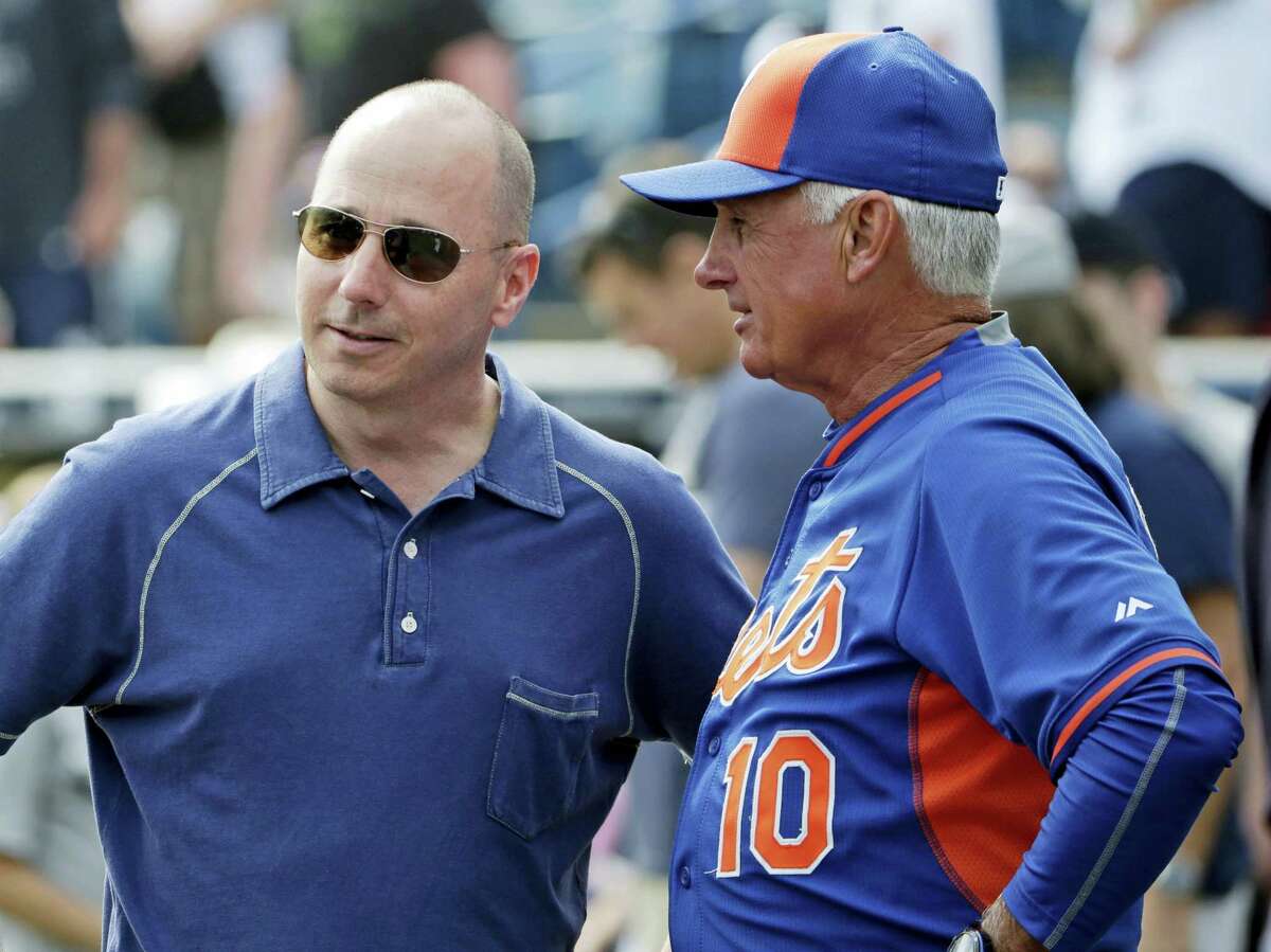 Yankees general manager Brian Cashman, left, talks to Mets manager Terry Collins before an exhibition game last year in Tampa, Fla.