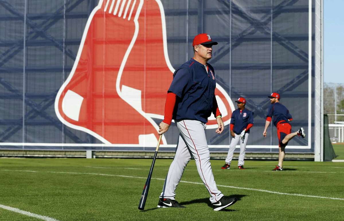 Red Sox manager John Farrell walks on a field during practice in Fort Myers, Fla., on Thursday.