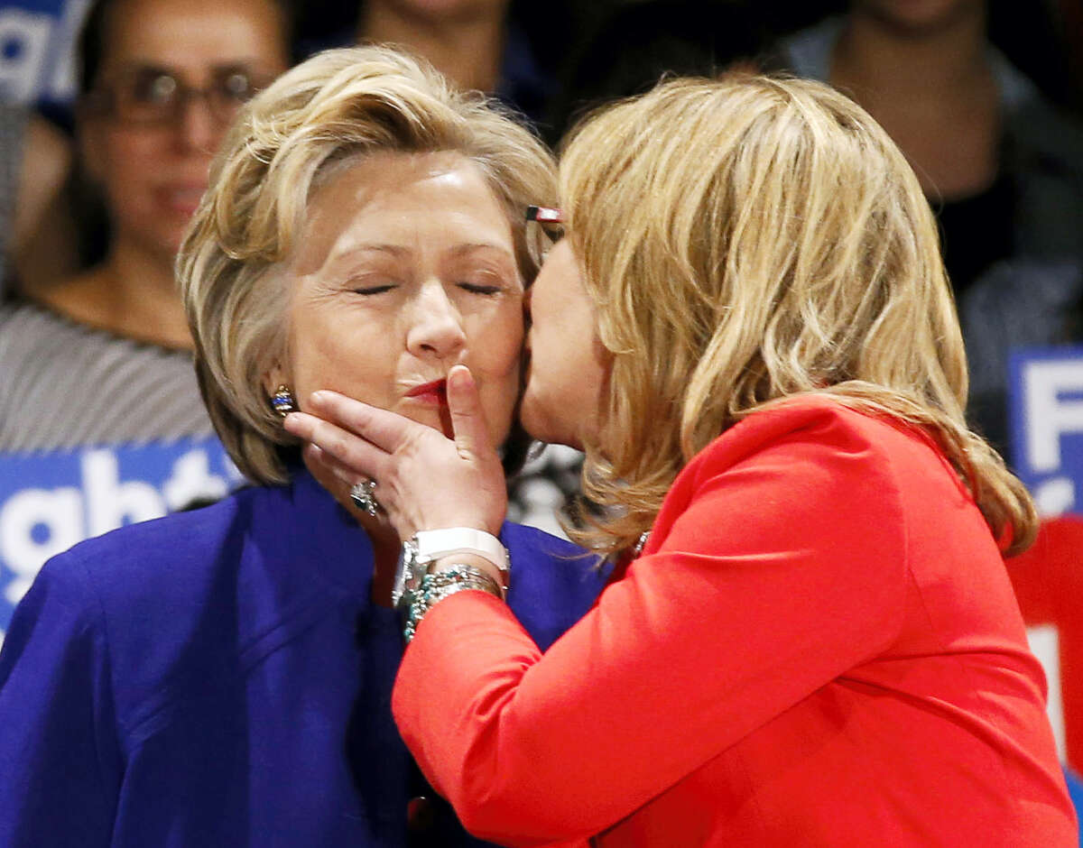 Former U.S. Representative Gabby Giffords, far right, plants a kiss on the cheek of Democratic presidential candidate Hillary Clinton at a Women for Hillary campaign event, Monday, April 18, 2016, in New York. Planned Parenthood president Cecile Richards, far left, and U.S. Senator Kirstin Gillibrand, second from left, joined Clinton at the event.
