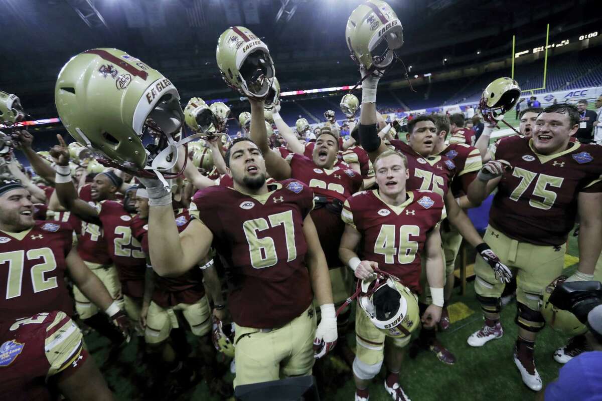Members of the Boston College team sing after the Quick Lane Bowl Monday in Detroit. Boston College defeated Maryland 36-30.